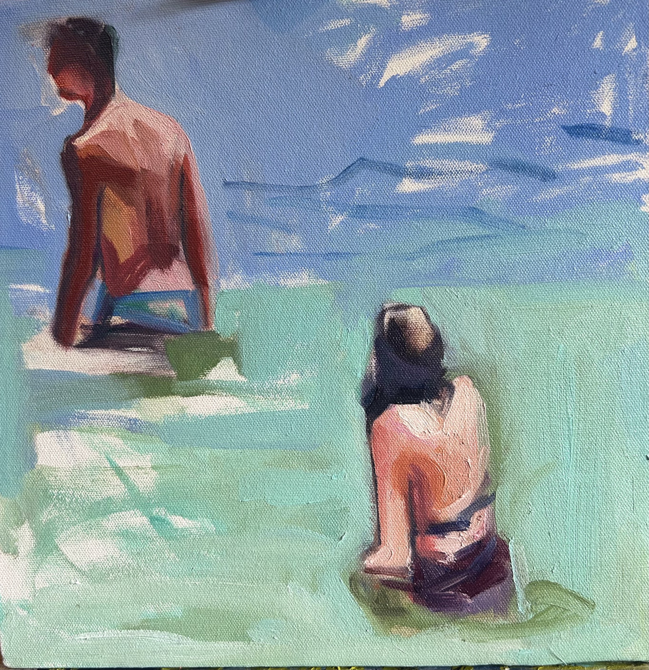 Two figures in turquoise water beneath a blue sky